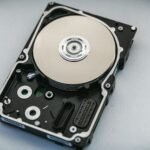 Open hard disk drive showing its internal platters and components, illustrating external drive backups
